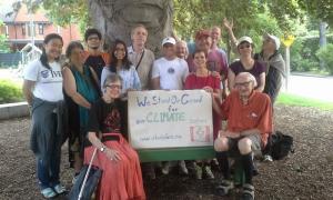 "Canada Day picnic with volunteers holding signs"