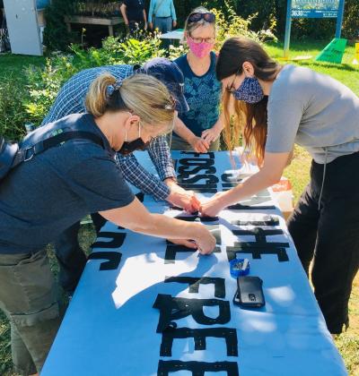 "volunteers making a banner"