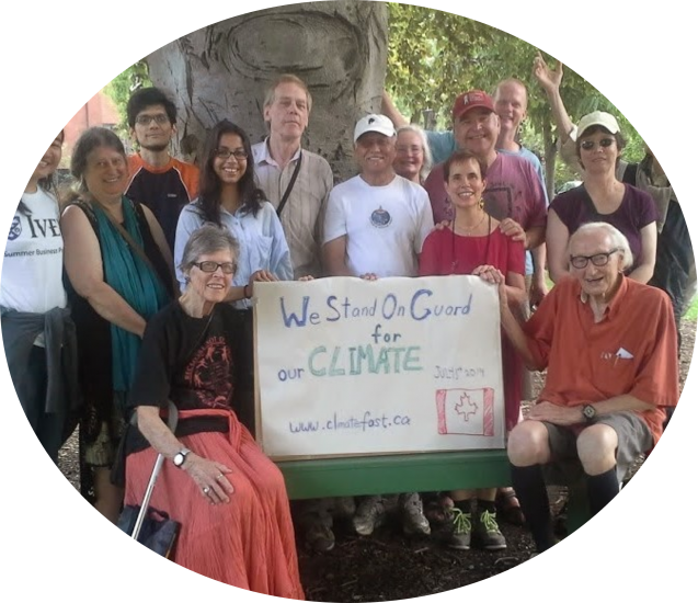 Volunteers gathered on Canada Day with signs urging federal climate action.